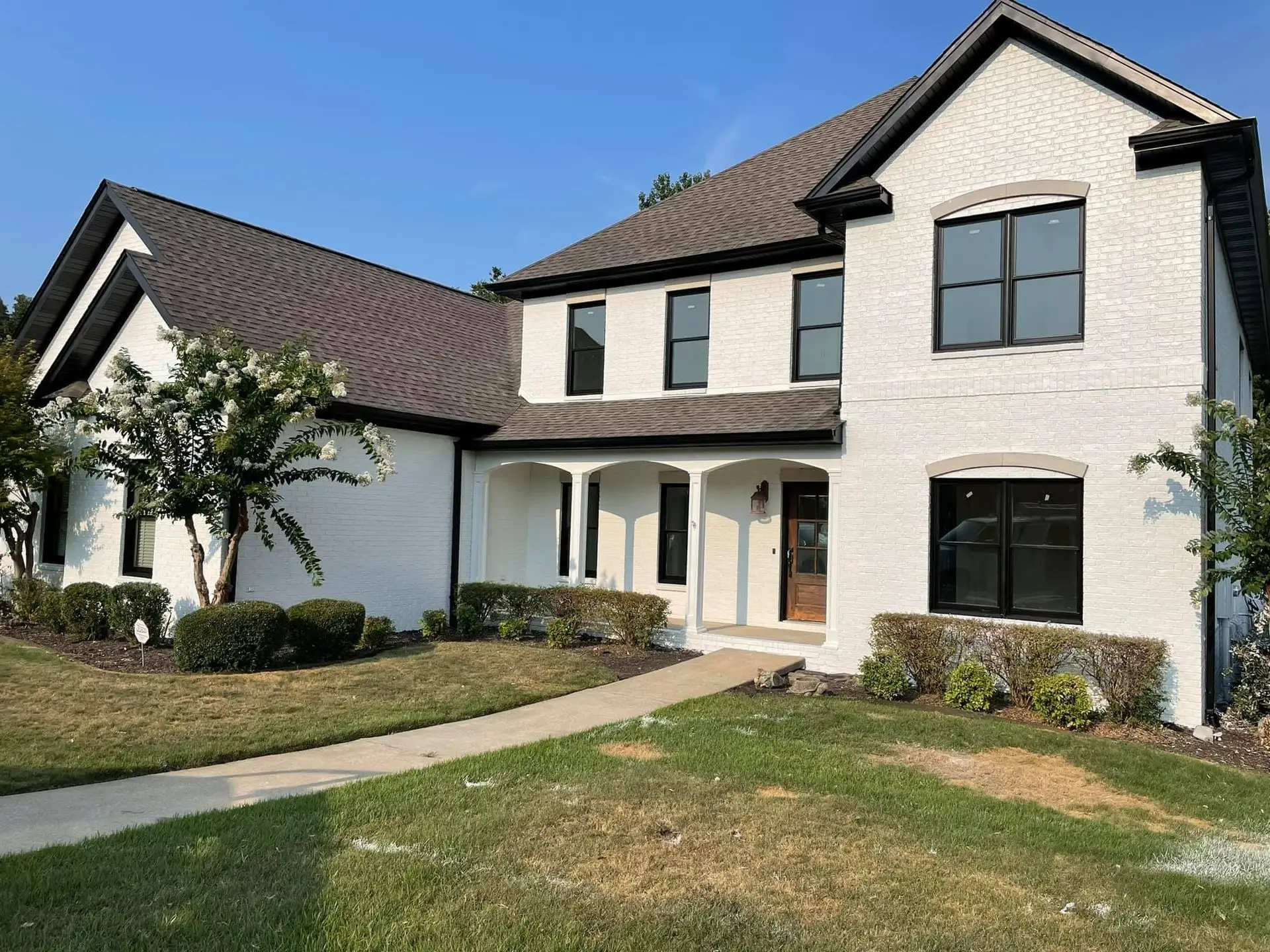 Two-story home exterior repainted by Alex's Painting & Remodeling.