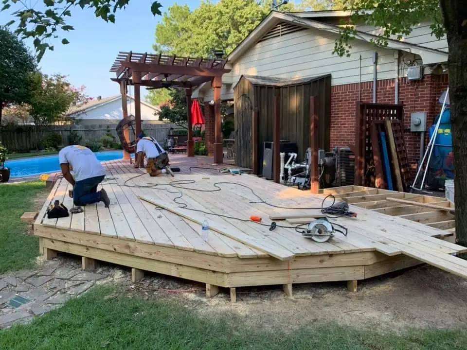 Completed deck staining project — rich finish, protected wood.