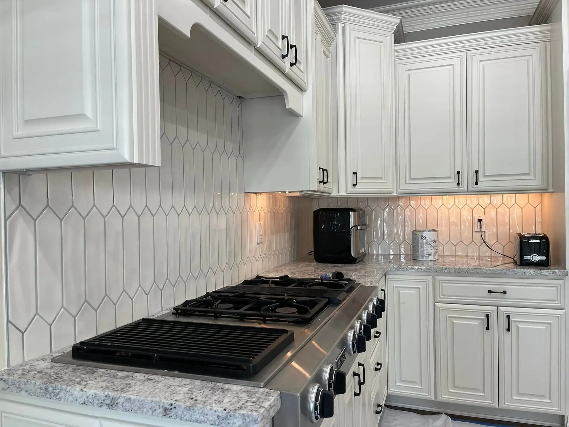 Custom kitchen cabinets and counters installed by Alex's Painting & Remodeling.