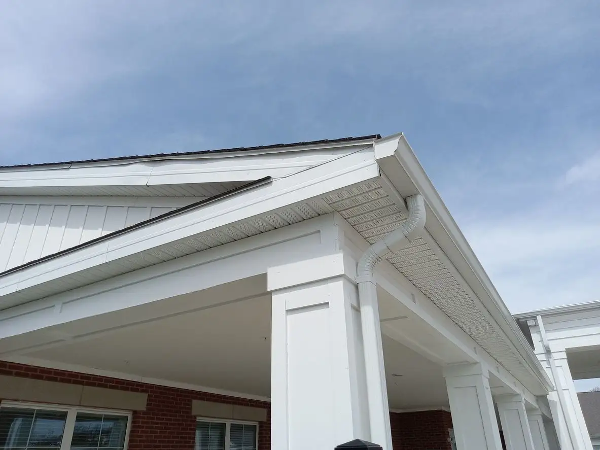 White house with newly installed seamless gutters.